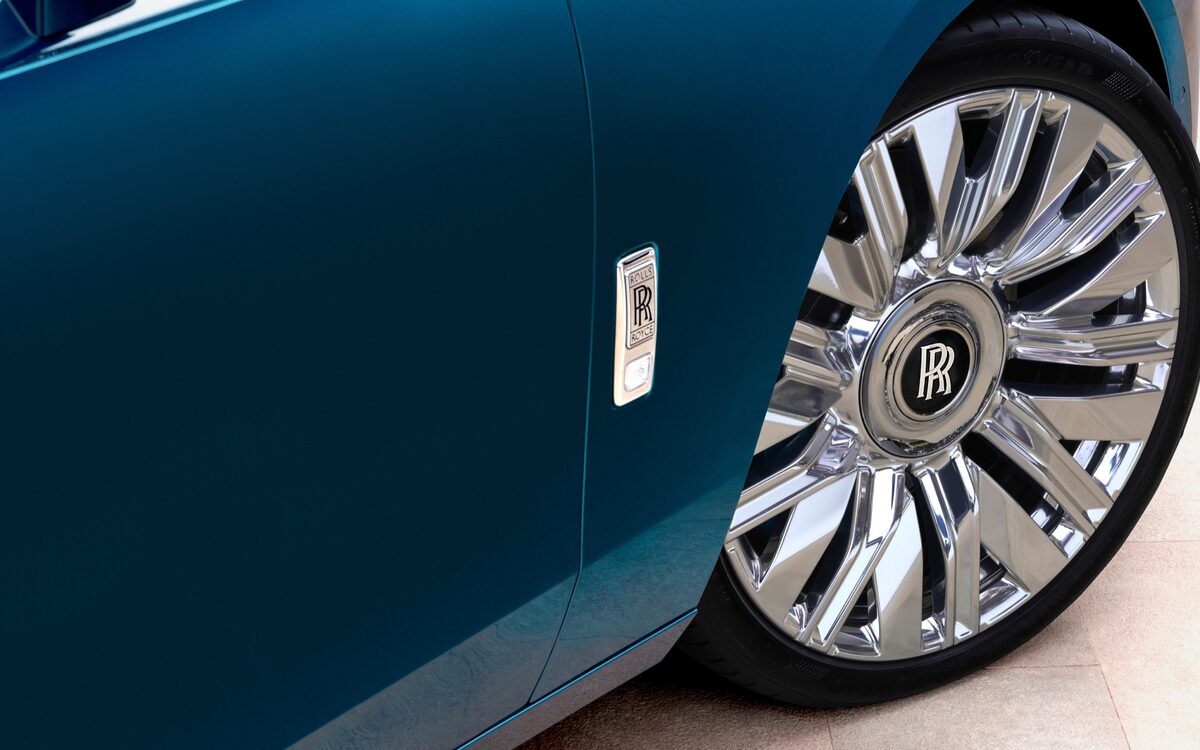Close-up of the Ghost front wheel and door in deep teal paint