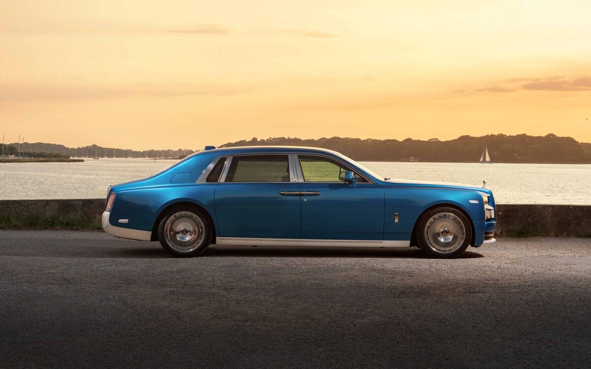 Rolls-Royce Phantom in blue, side profile on a waterside road