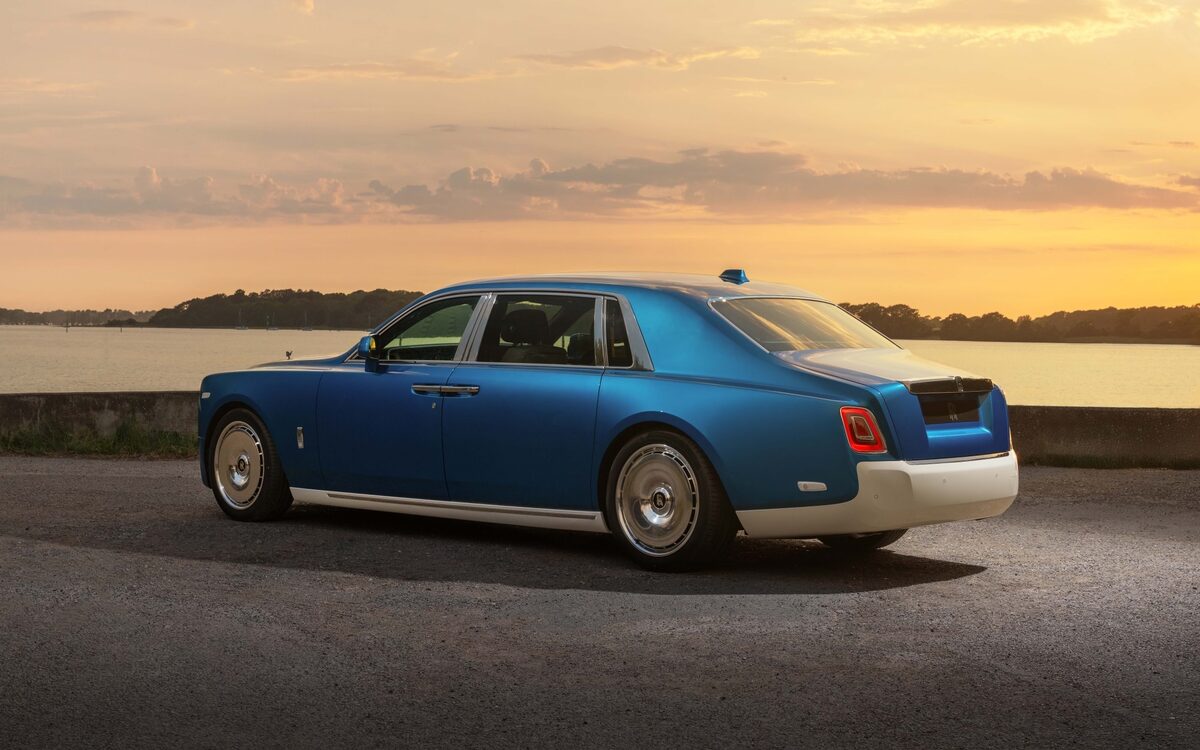 Rolls-Royce Phantom in blue, rear three-quarter view at sunset