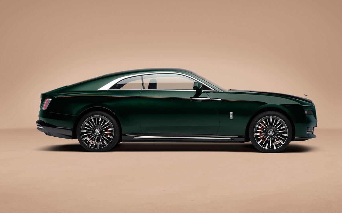 Rolls-Royce Spectre in dark green with black bonnet, side profile in a studio