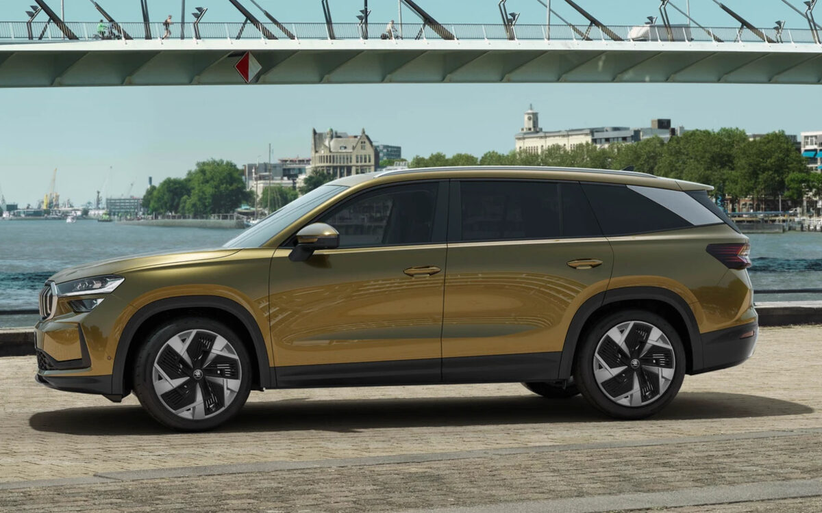 Skoda Kodiaq in Bronx Gold, side profile parked beside a waterfront