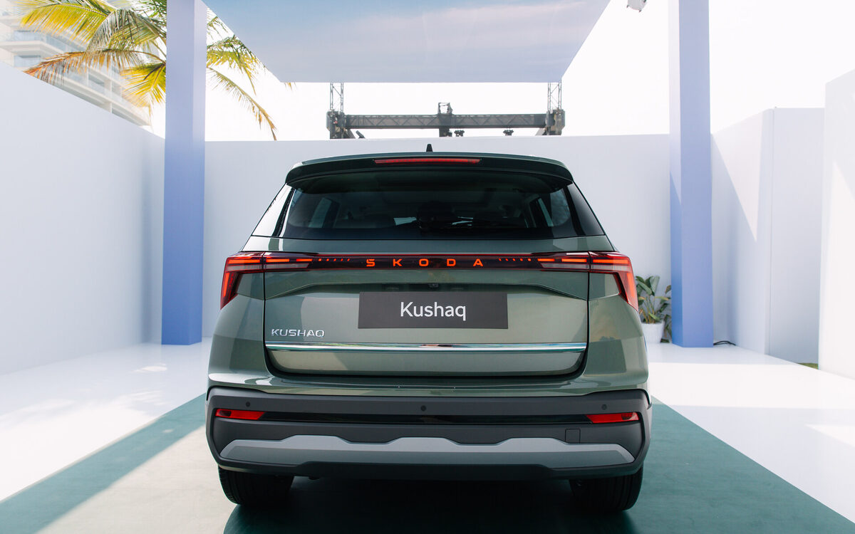 Skoda Kushaq in olive green seen from directly behind, with light-bar tail lamps