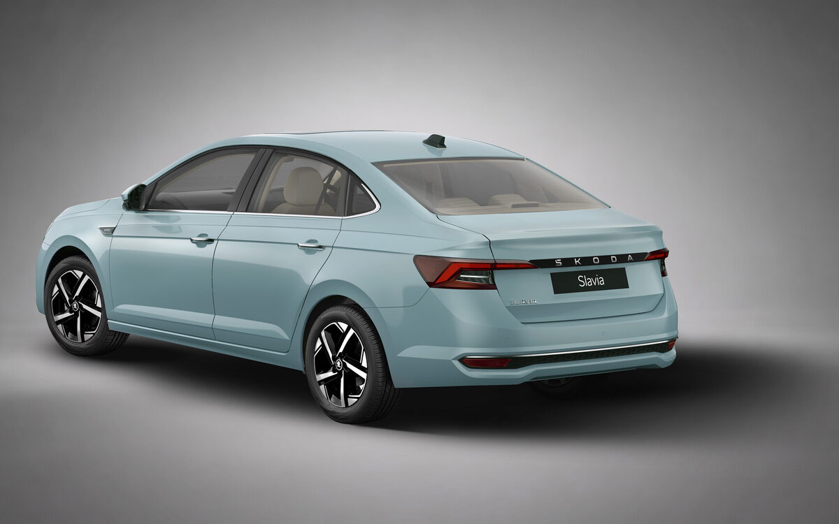 Updated Skoda Slavia in light blue, rear three-quarter view in a studio