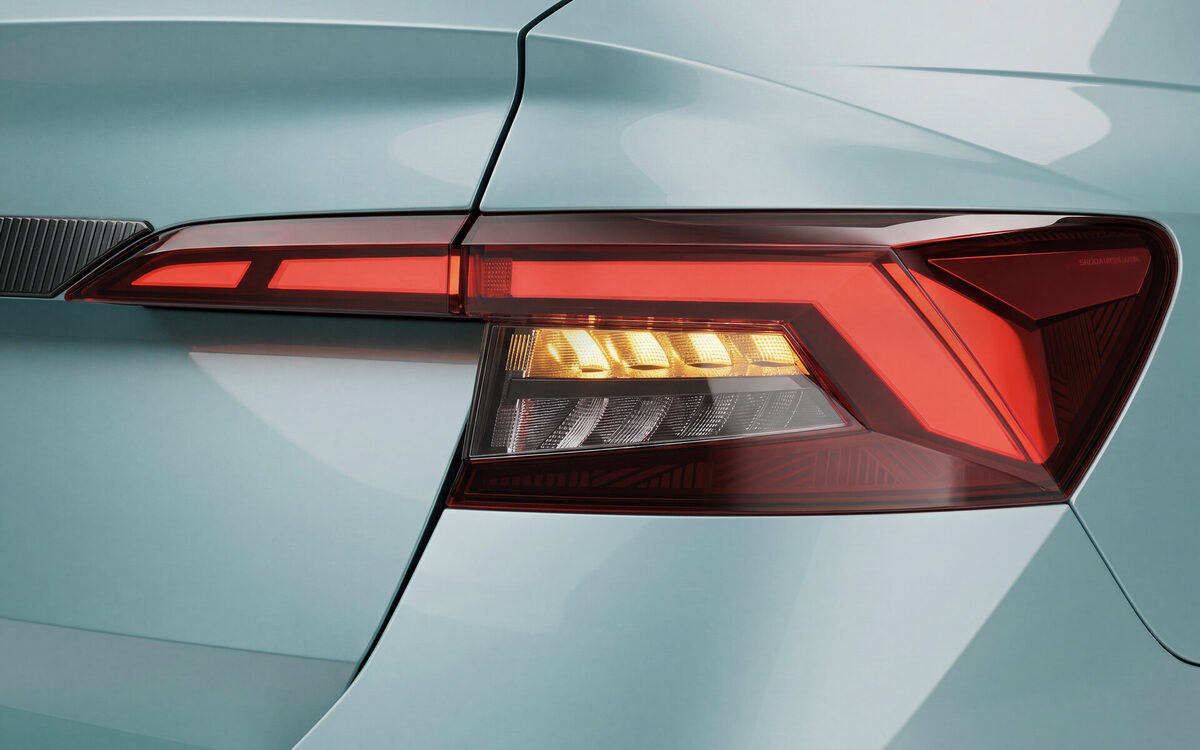 Close-up of the Skoda Slavia LED tail lamp on a light blue body