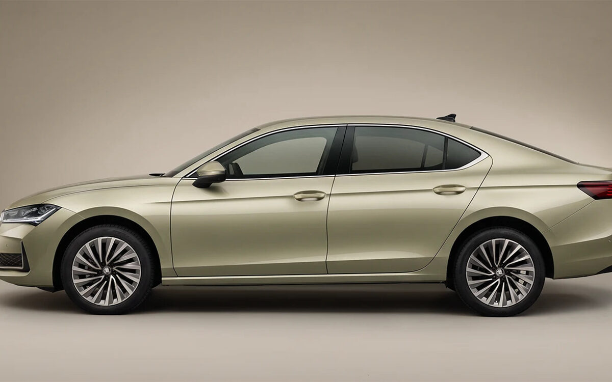 Skoda Superb in a pale gold-green, full side profile studio shot