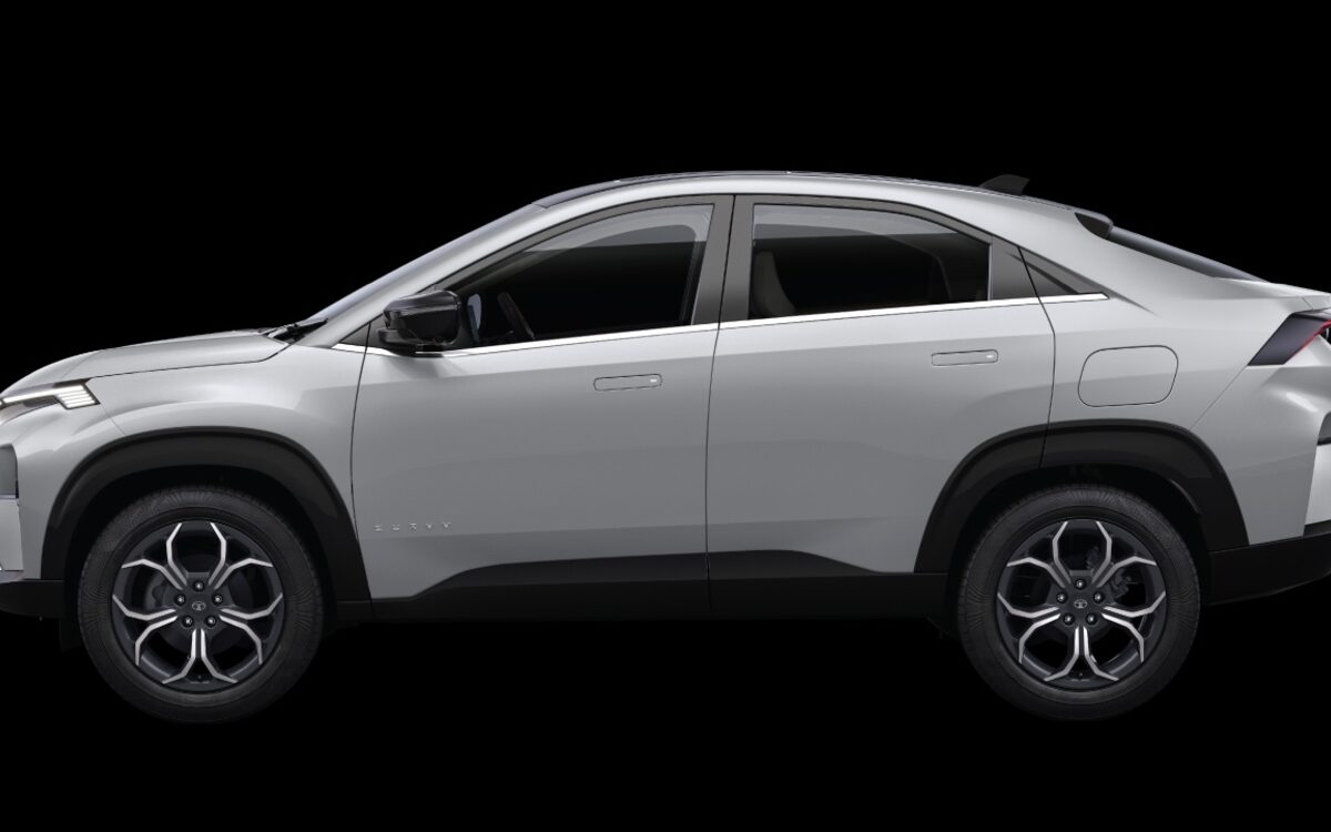 Tata Curvv in silver, side profile showing the sloping coupe roofline, against a black background