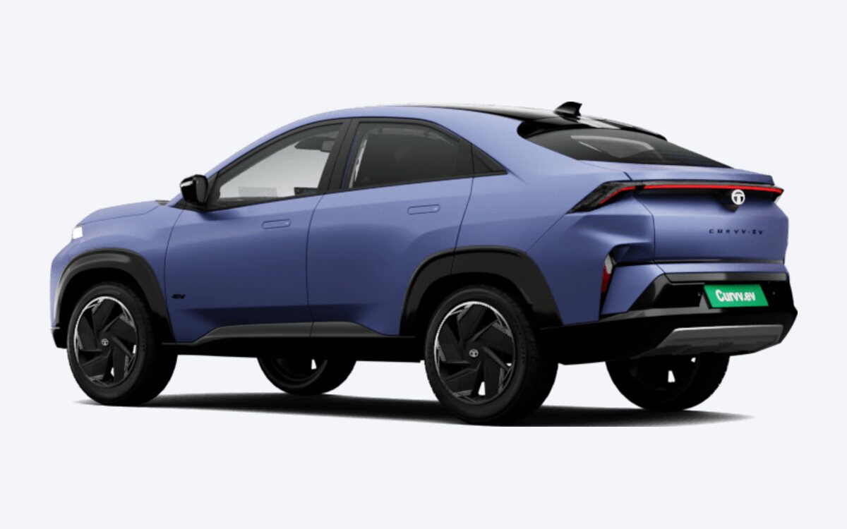 Tata Curvv.ev in Virtual Sunrise, rear three-quarter view showing the coupe roofline