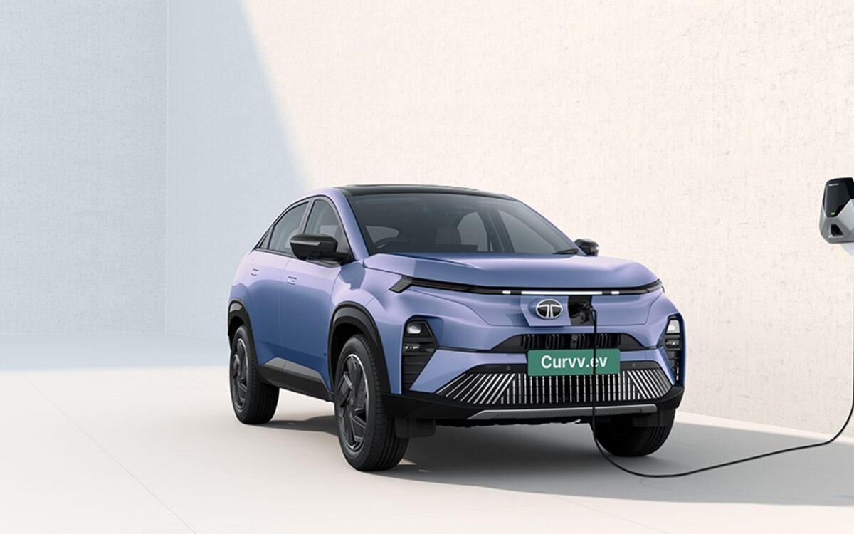 Tata Curvv.ev plugged into a wall charger