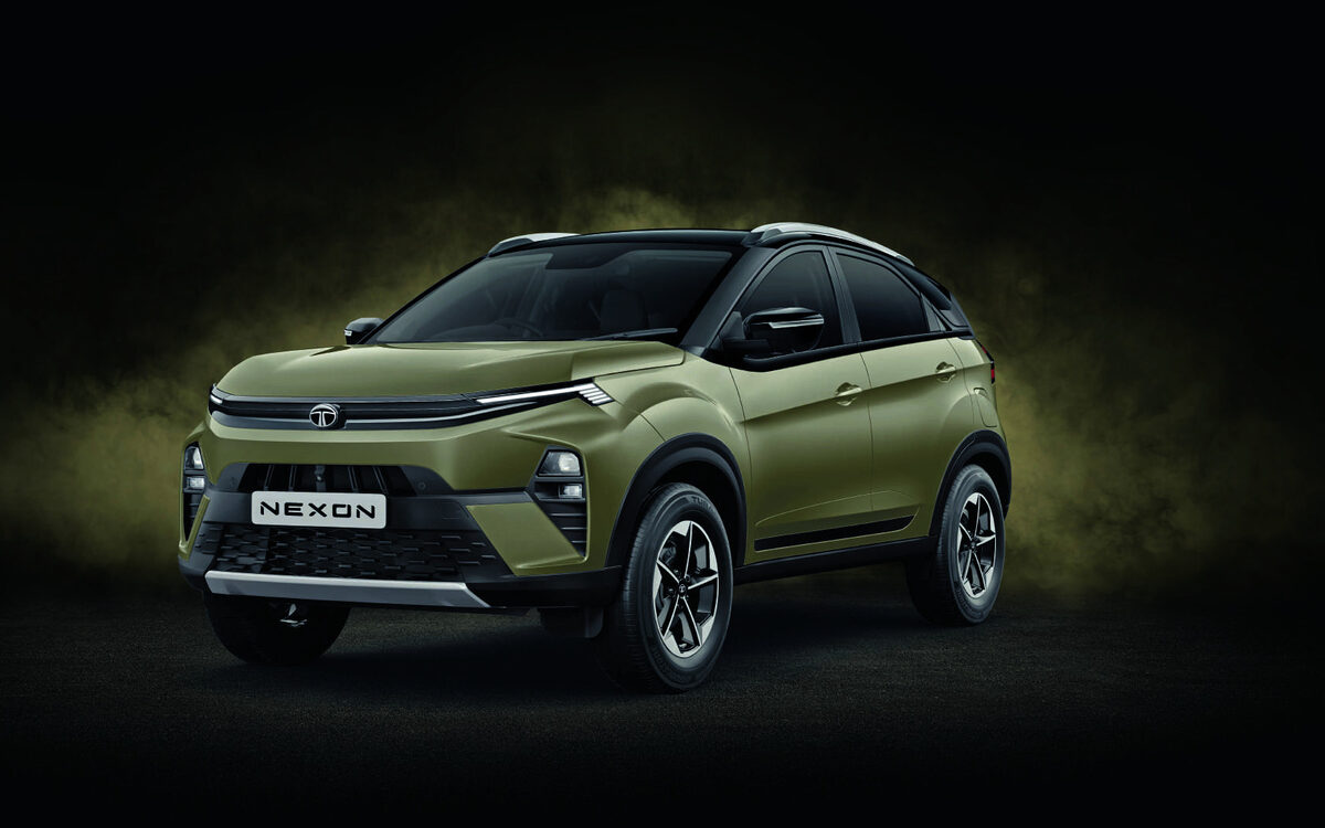 Tata Nexon in olive green, front three-quarter view against a dark studio background