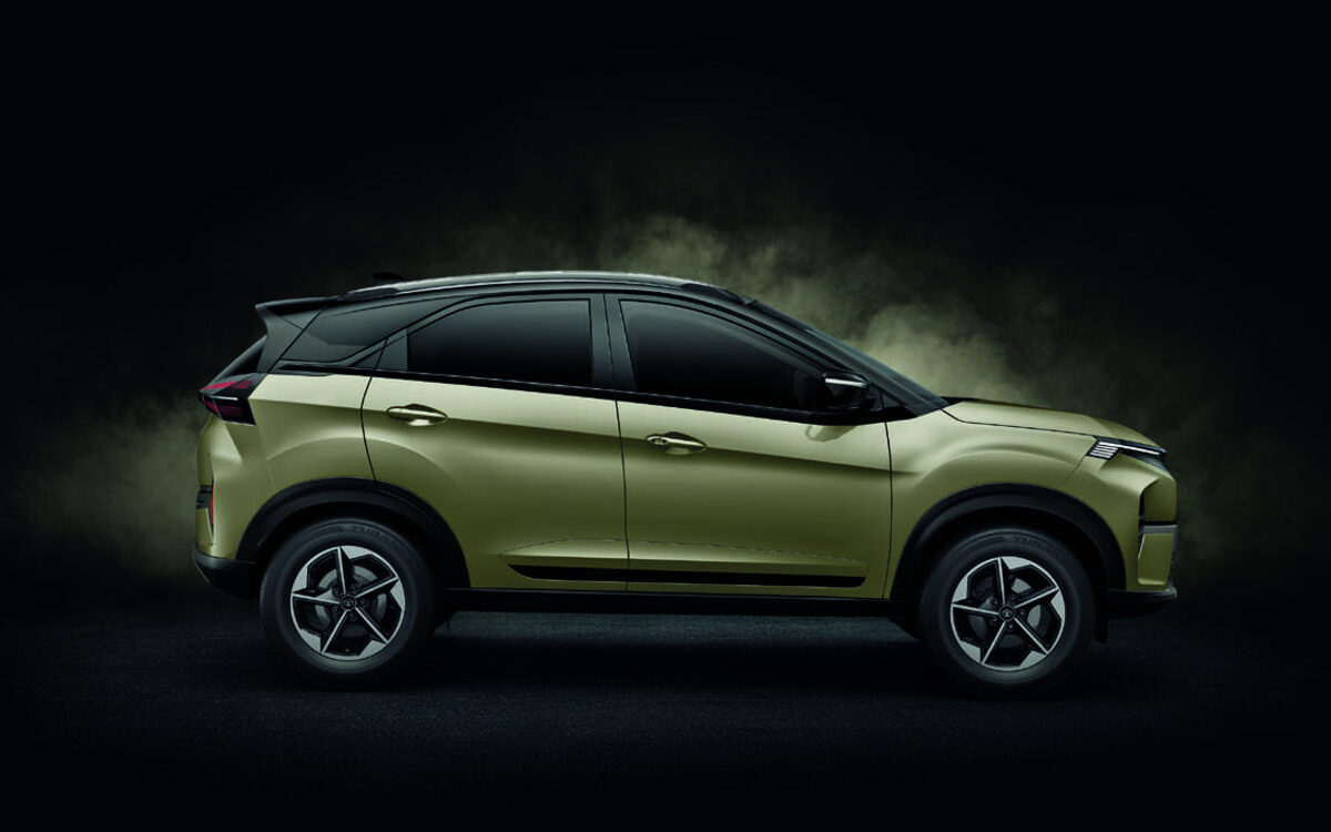 Tata Nexon in olive green, side profile against a dark studio background