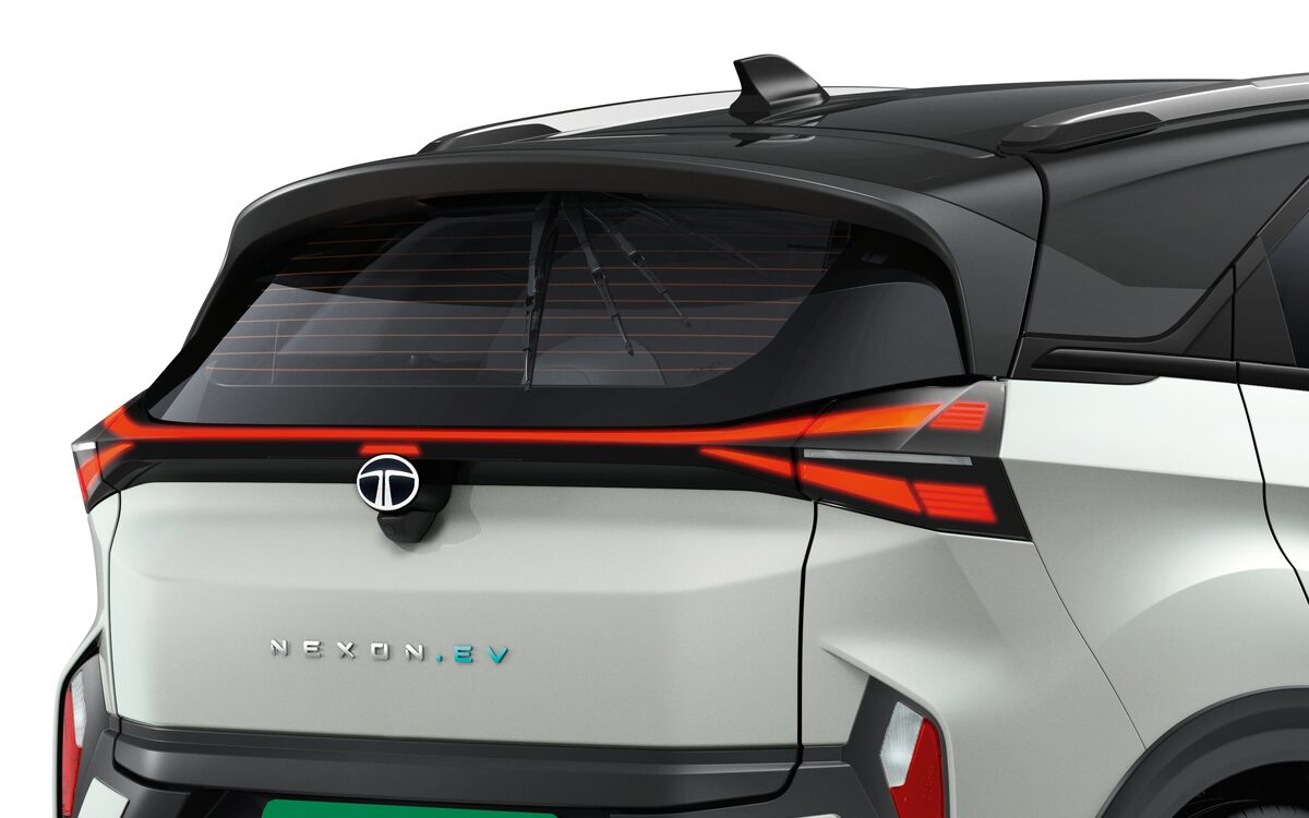 Tata Nexon.ev in white with a black roof, seen from the rear with its connected LED tail lamp