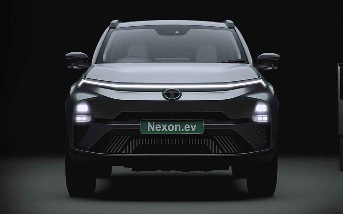 Tata Nexon.ev front with its full-width LED light bar and headlamps lit