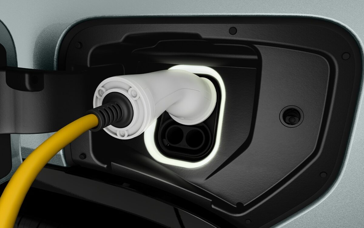 The Tata Sierra.ev charging port with its lit ring and the charger plugged in