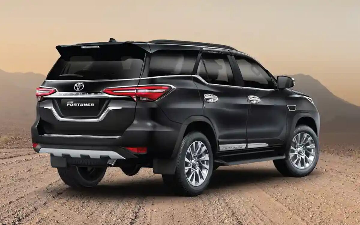 Black Toyota Fortuner parked on a desert track, rear three-quarter view