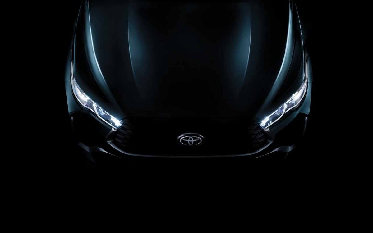 Close-up of the Toyota Innova HyCross front with LED headlamps lit against a black background