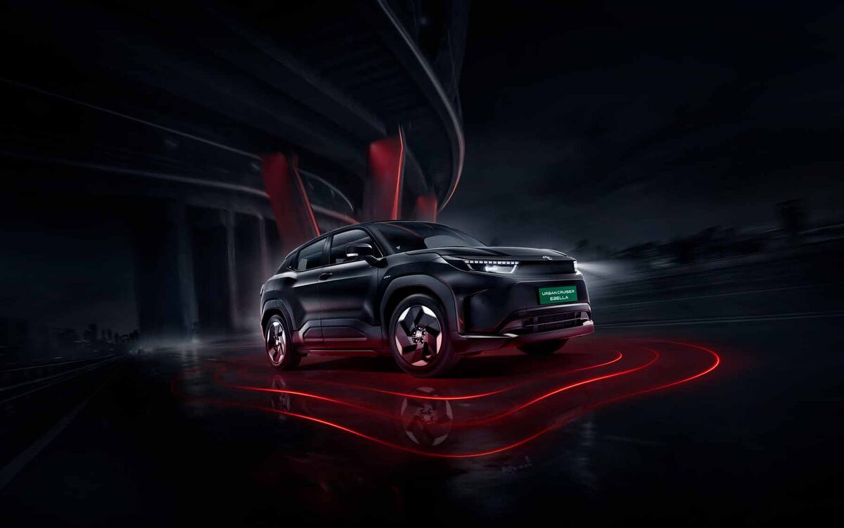 Toyota Urban Cruiser Ebella in black, side three-quarter view under a bridge with red light trails