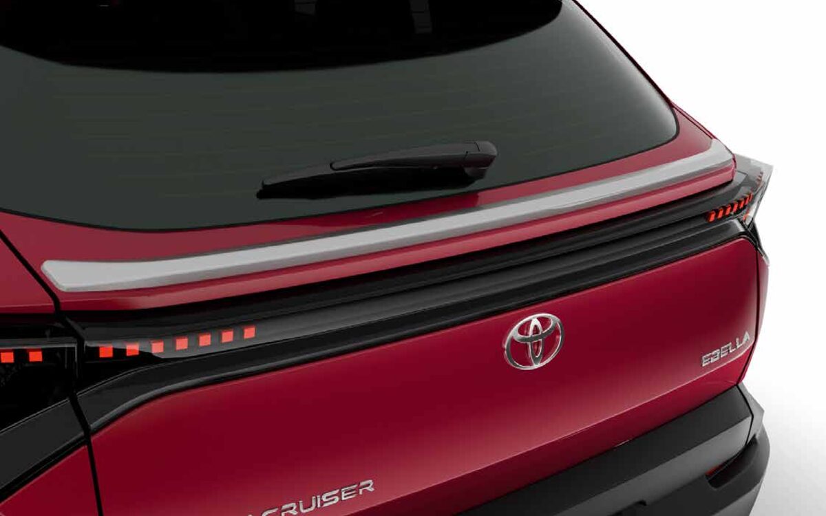Close-up of the red Ebella tailgate with roof spoiler, light bar and Toyota badge