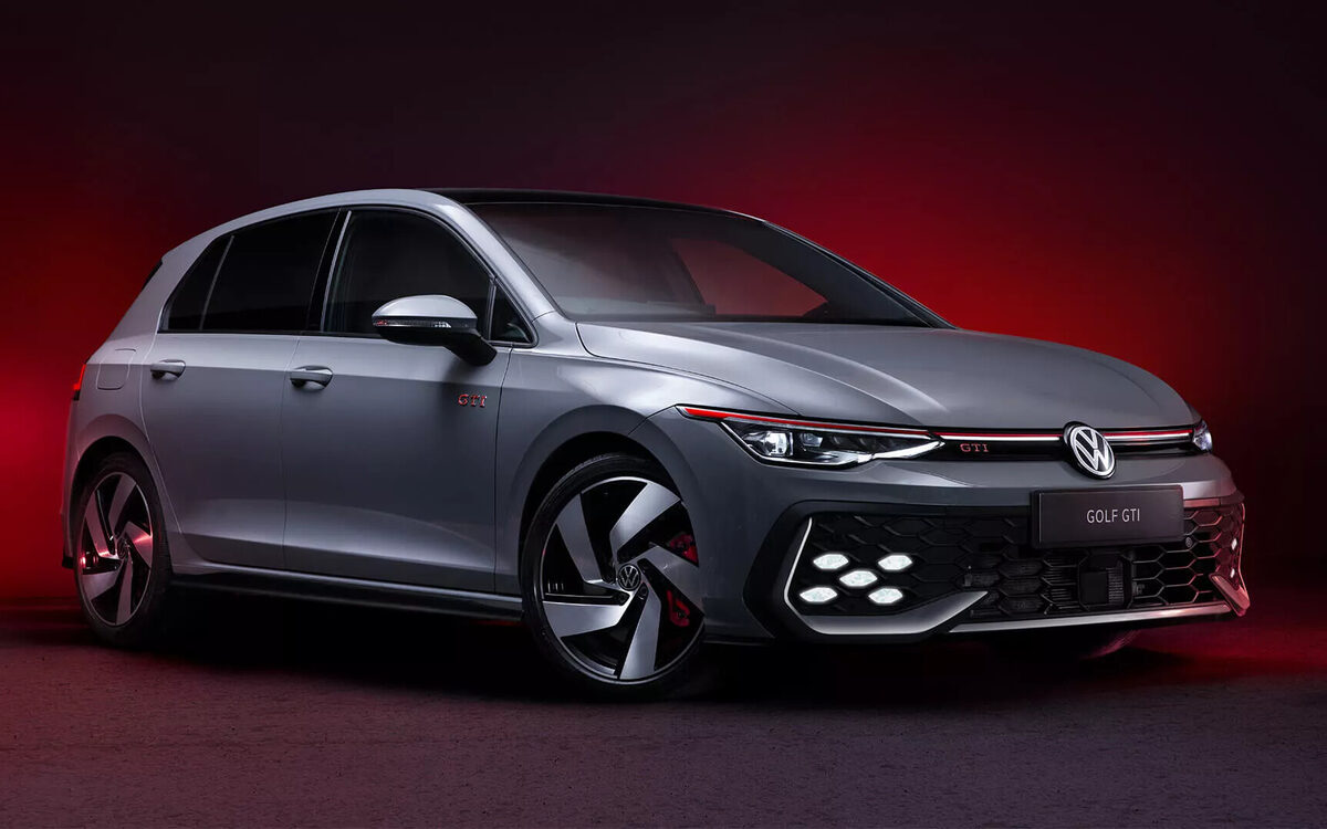 Grey Golf GTI in a studio with a deep red backdrop, front three-quarter view with honeycomb fog lamps