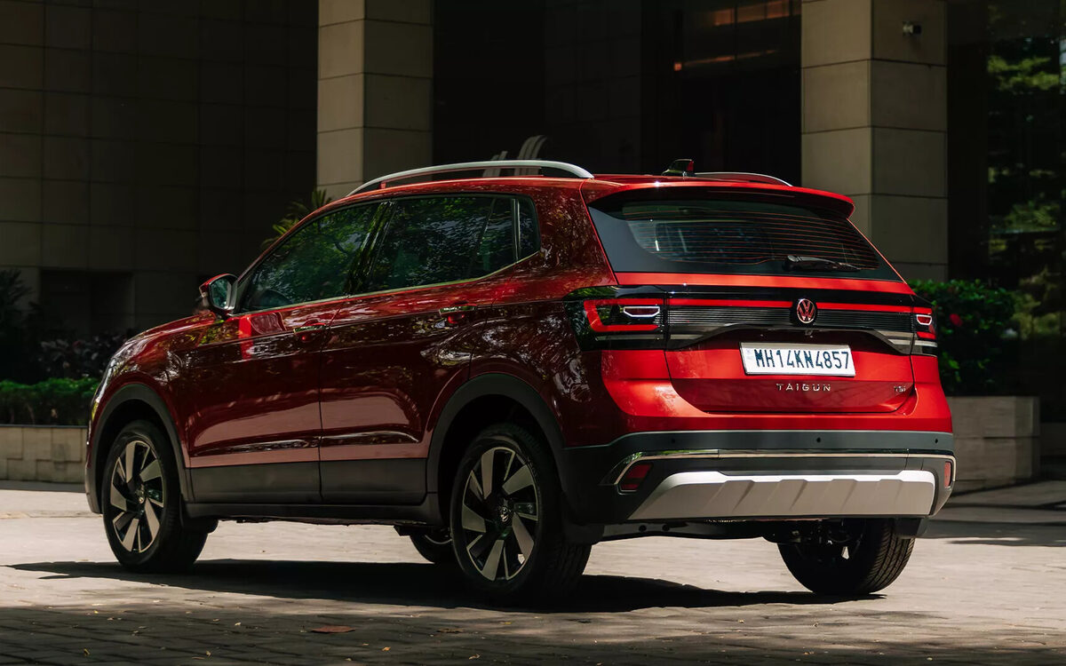 Volkswagen Taigun in red, rear three-quarter view with connected LED tail lamps