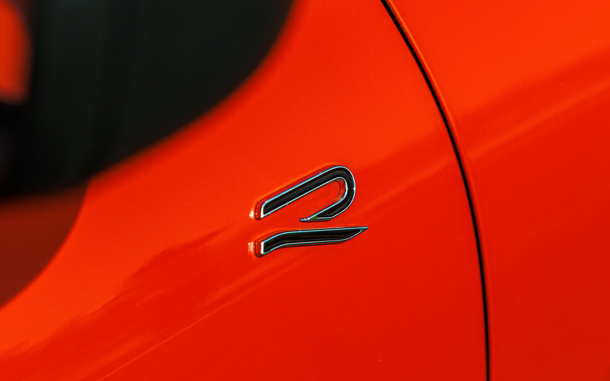 Close-up of the R badge on the red body of the Tiguan R-Line